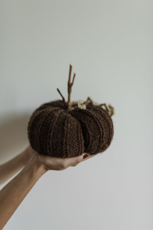 A Person Holding Brown Yarn Ball