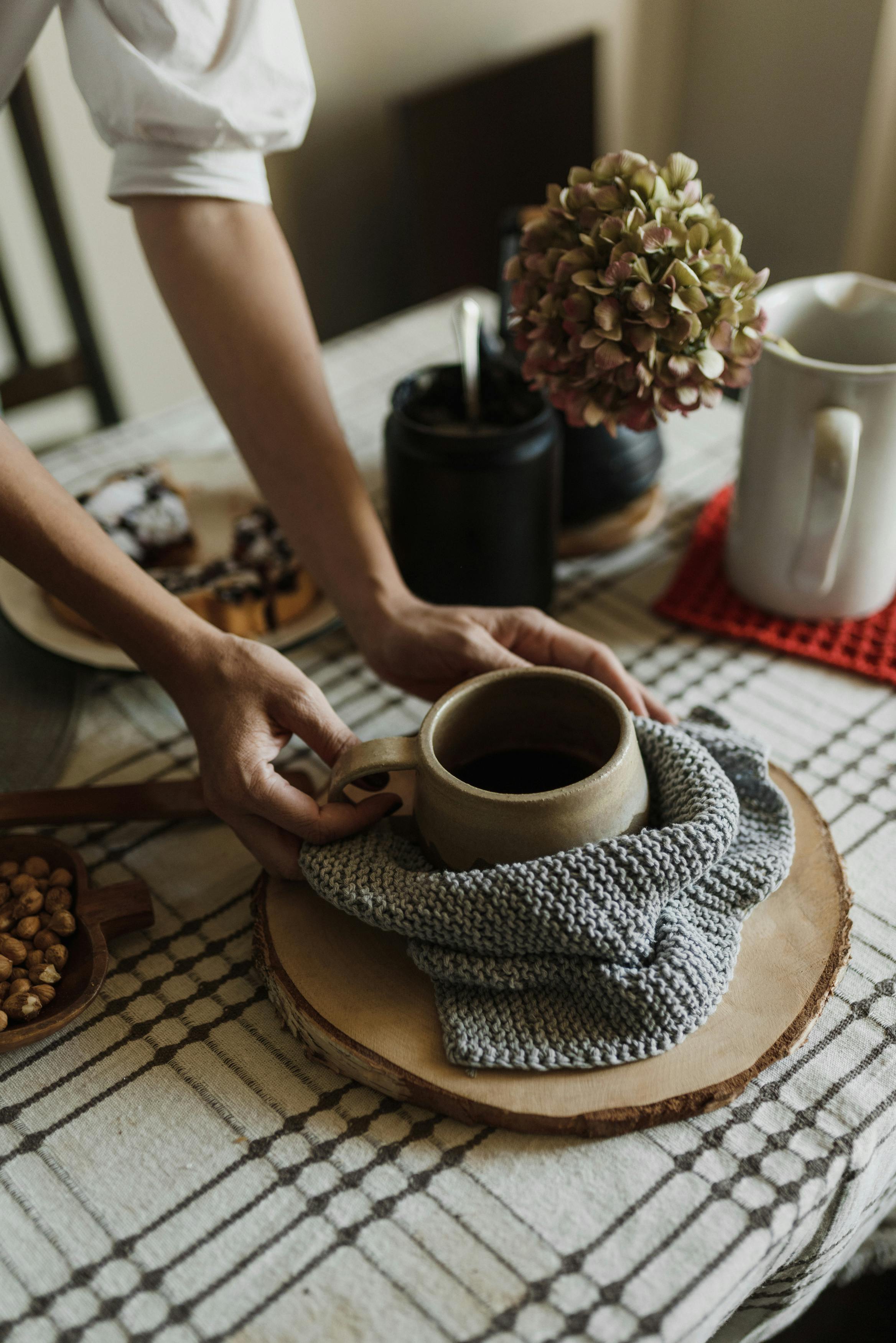 Warm breakfast table with a ceramic mug and cozy decor, inviting a rustic home atmosphere.