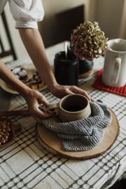 Hands lifting a stoneware bowl, photo by Arina Krasnikova on Pexels