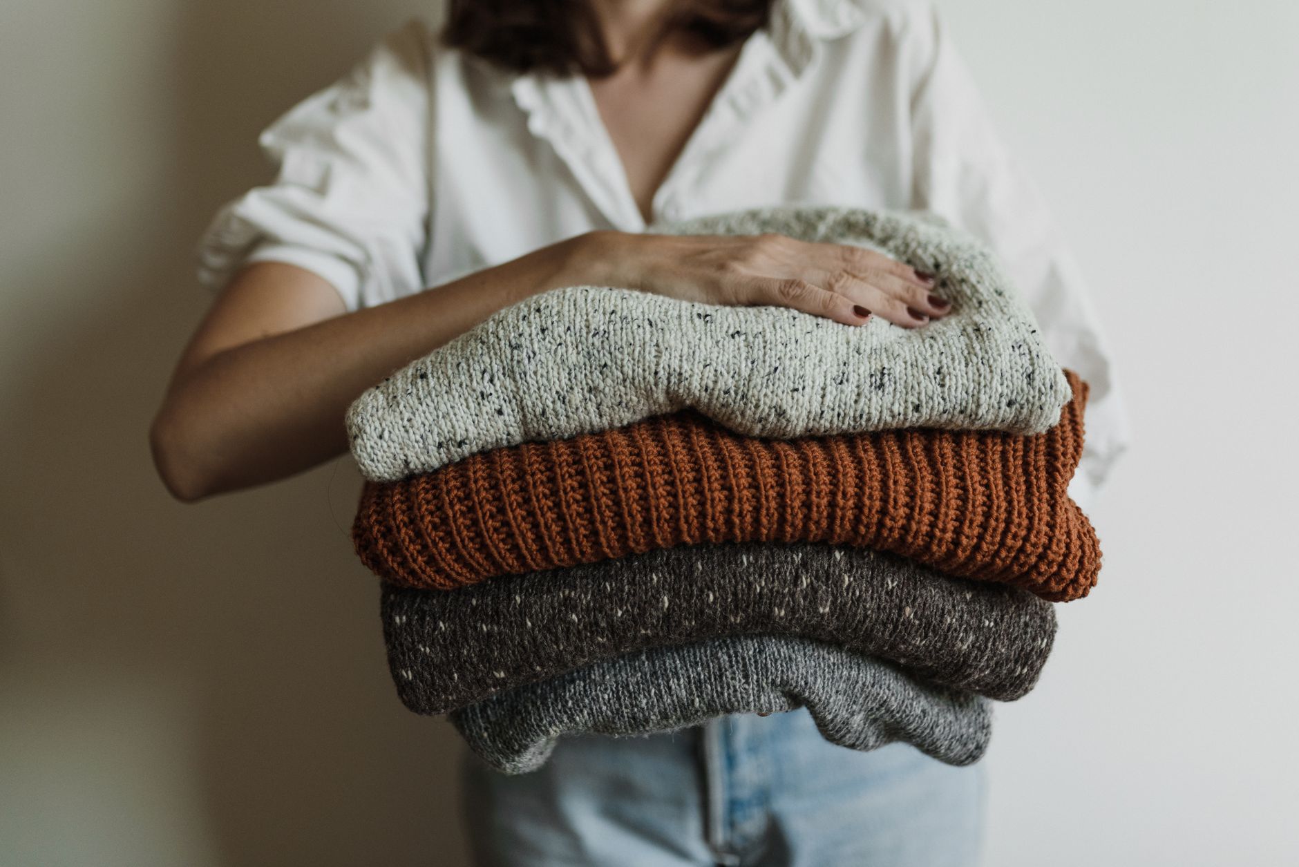 Close-up comparison of cashmere sweater surface before and after five wears showing pilling development