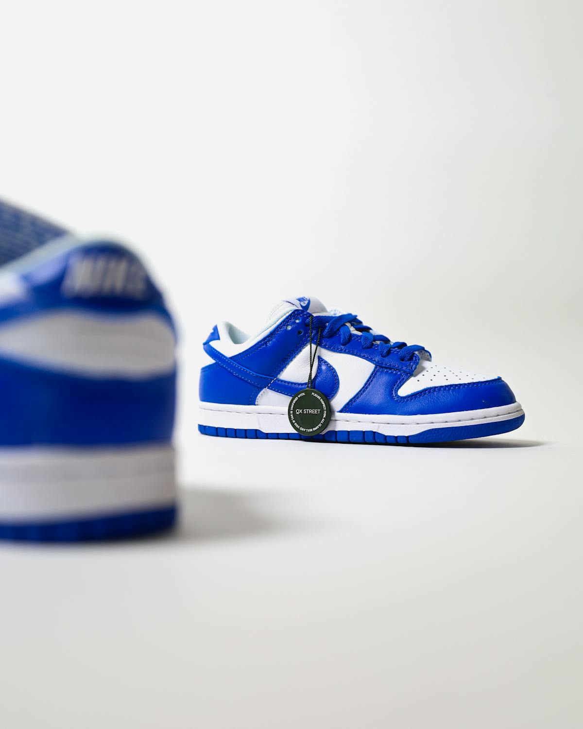 Person wearing minimalist streetwear outfit with long coat and neutral tones walking in the city