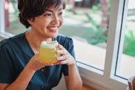 Happy Asian woman with cocktail