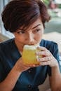 Asian woman drinking fresh beverage