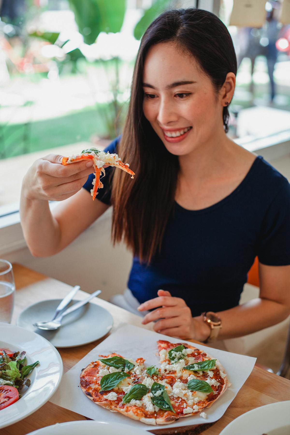 Multiple rice bowls with different colorful vegetable toppings on a table
