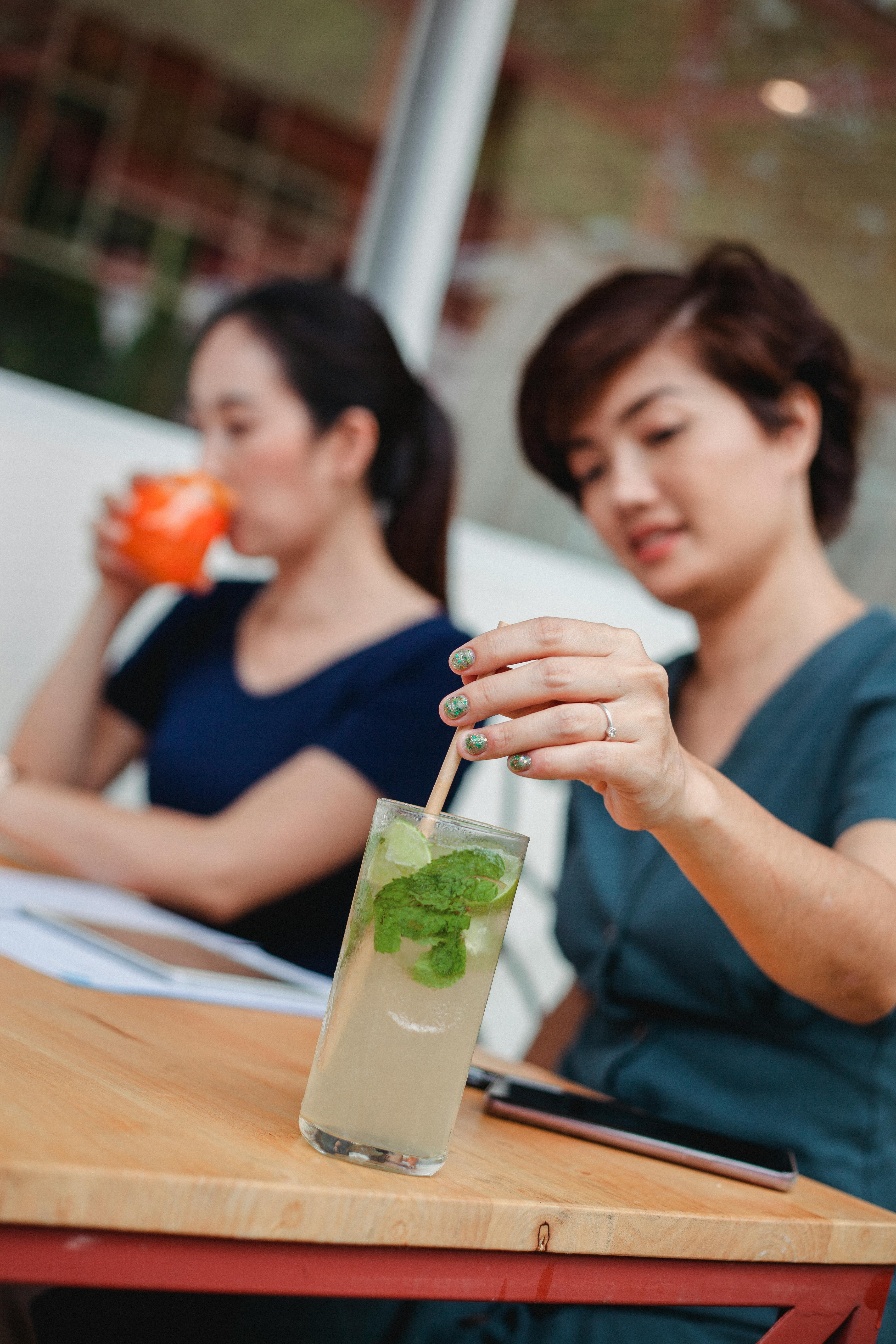 asian women drinking cocktails during work