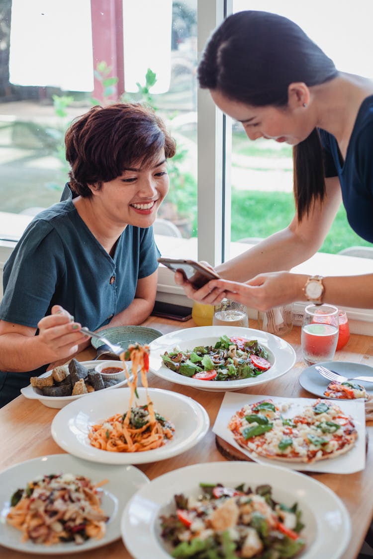 Asian Women Having Dinner In Restaurant