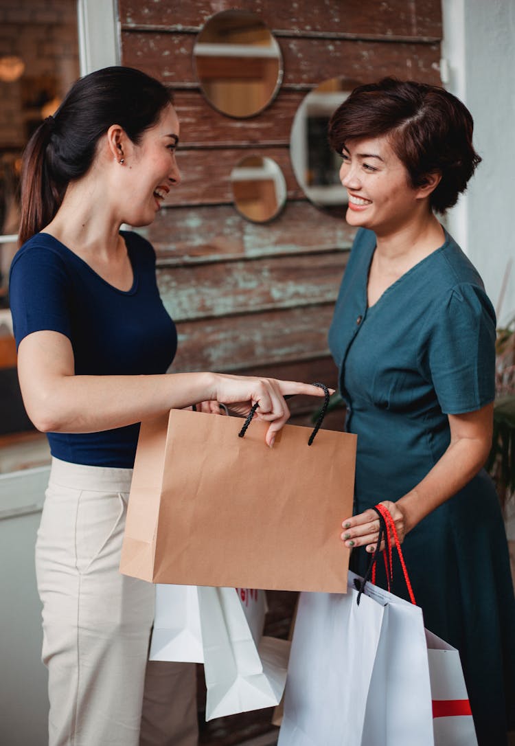 Happy Women With Paper Shopping Bags