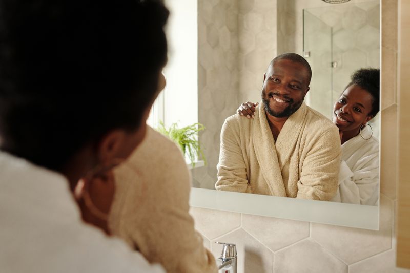 Couple smiling and admiring their newly remodeled bathroom together