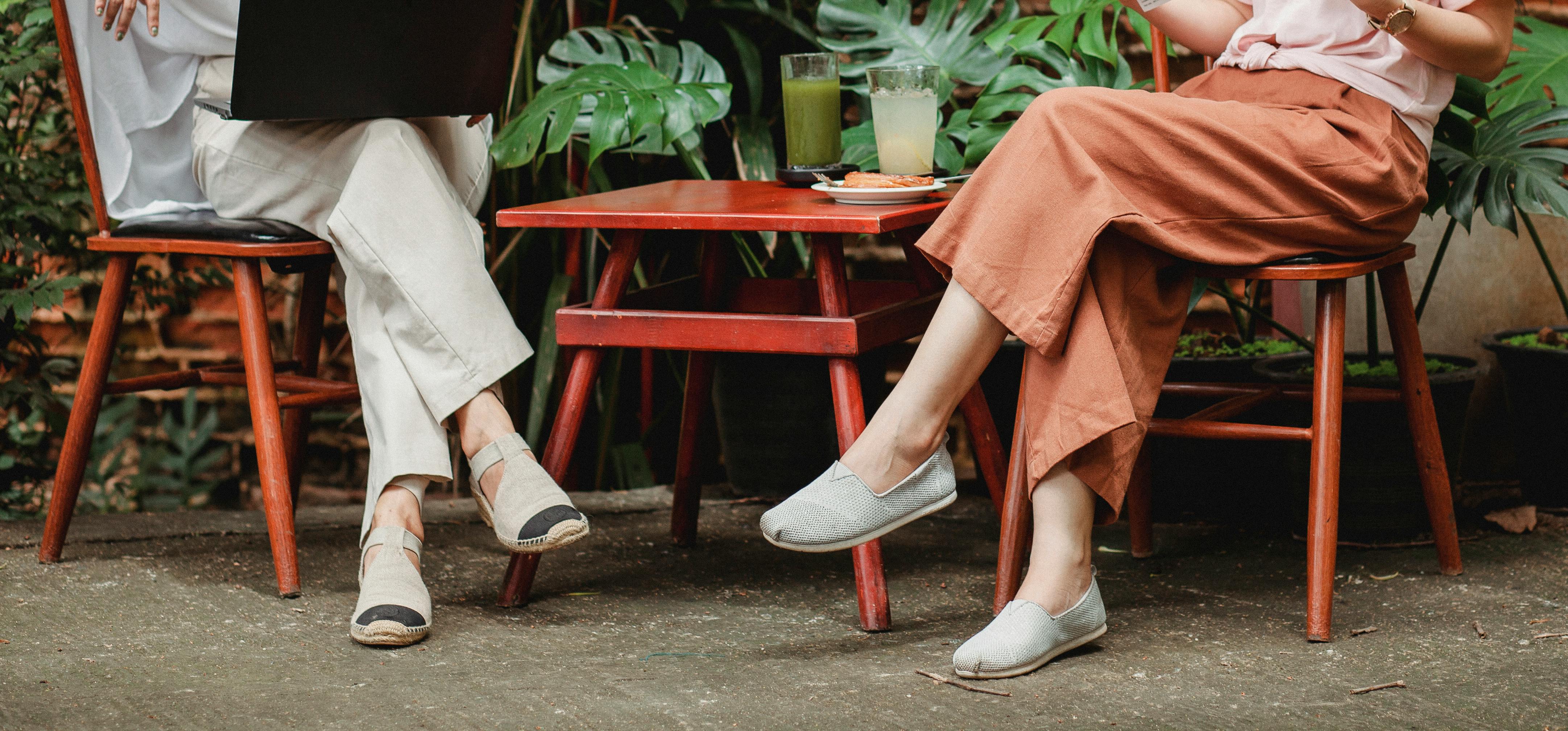 crop stylish women on terrace of cafe