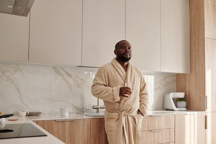 A Man Holding A Glass Of Water 