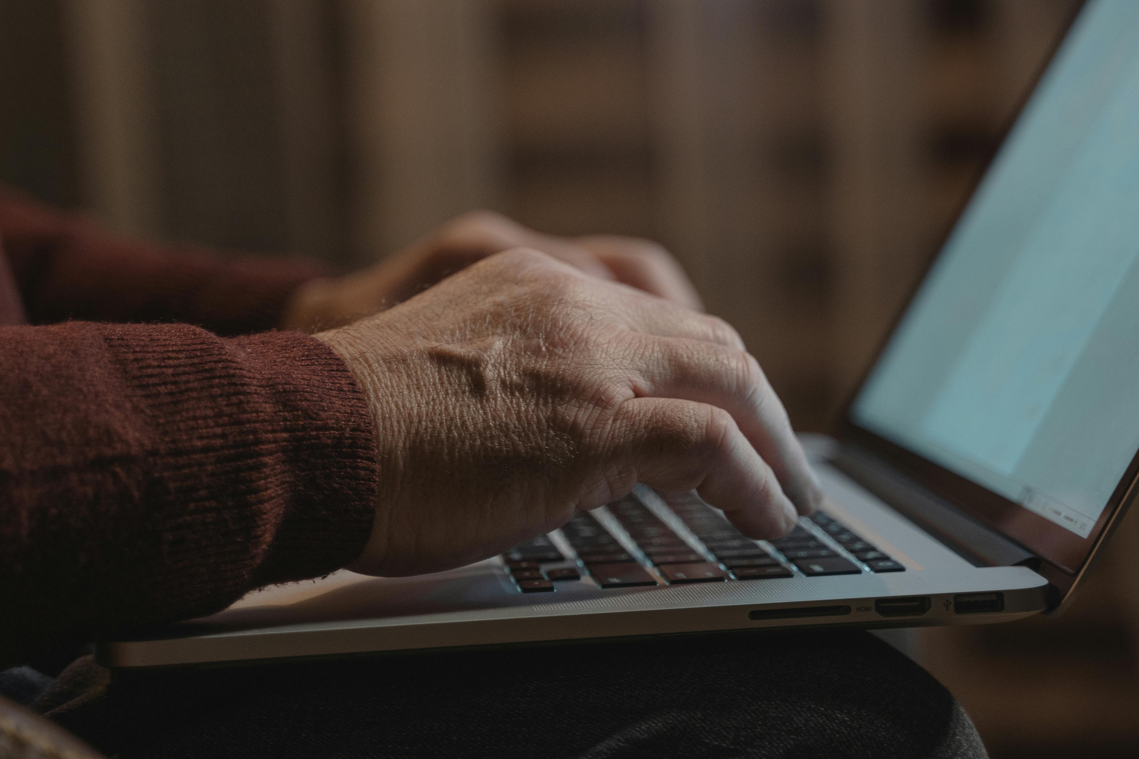 person typing on laptop computer