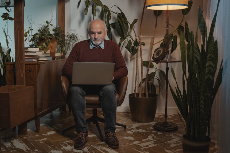 An Elderly Man Using A Laptop