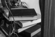 Grayscale Photo of Books on Table