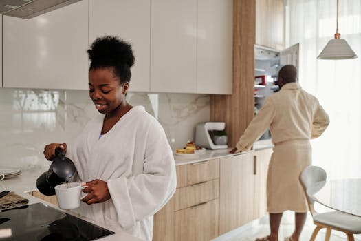 A couple preparing breakfast coffee in a bright, modern kitchen, starting the day.