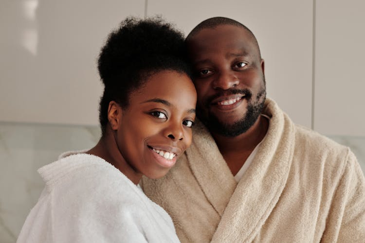 Smiling Couple Wearing Bathrobes 