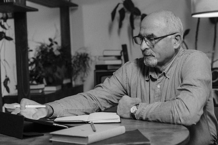 Monochrome Photo Of An Elderly Man Using An Ipad 