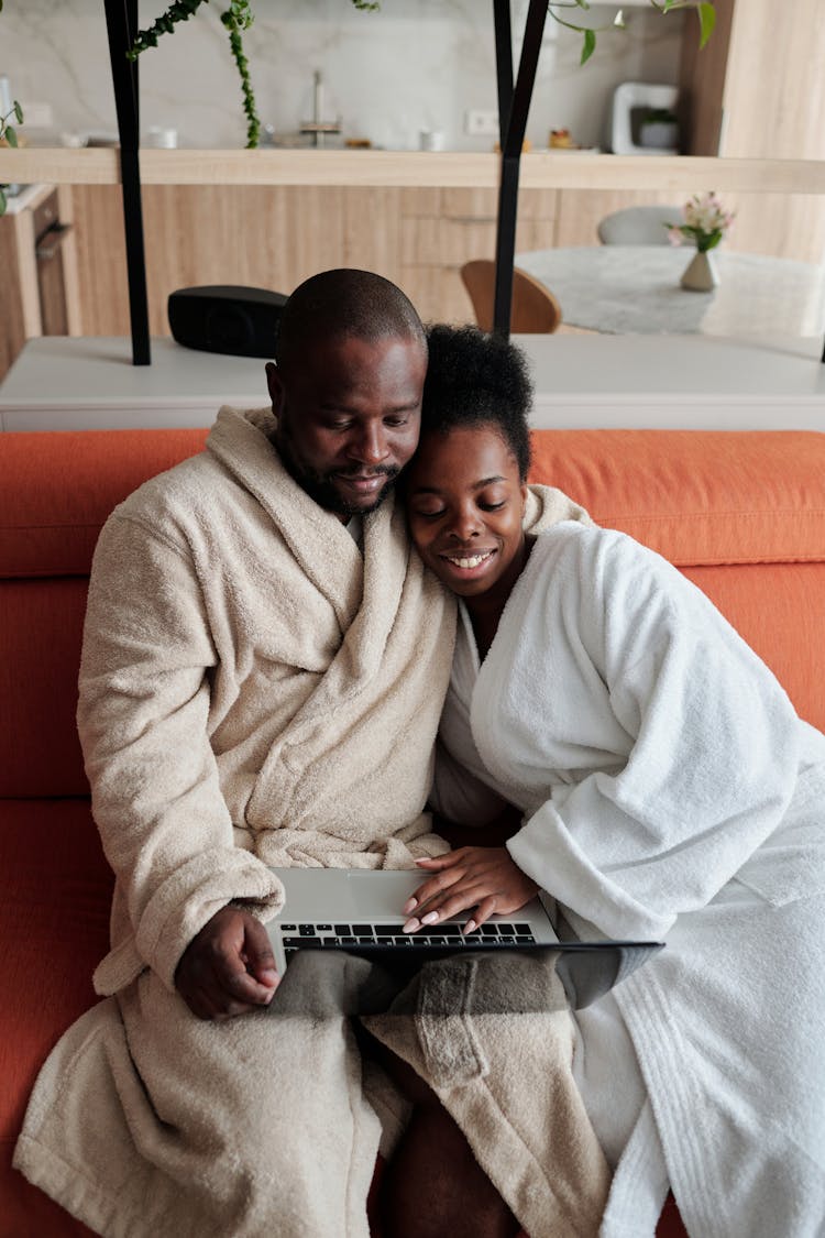 A Couple Watching In The Laptop