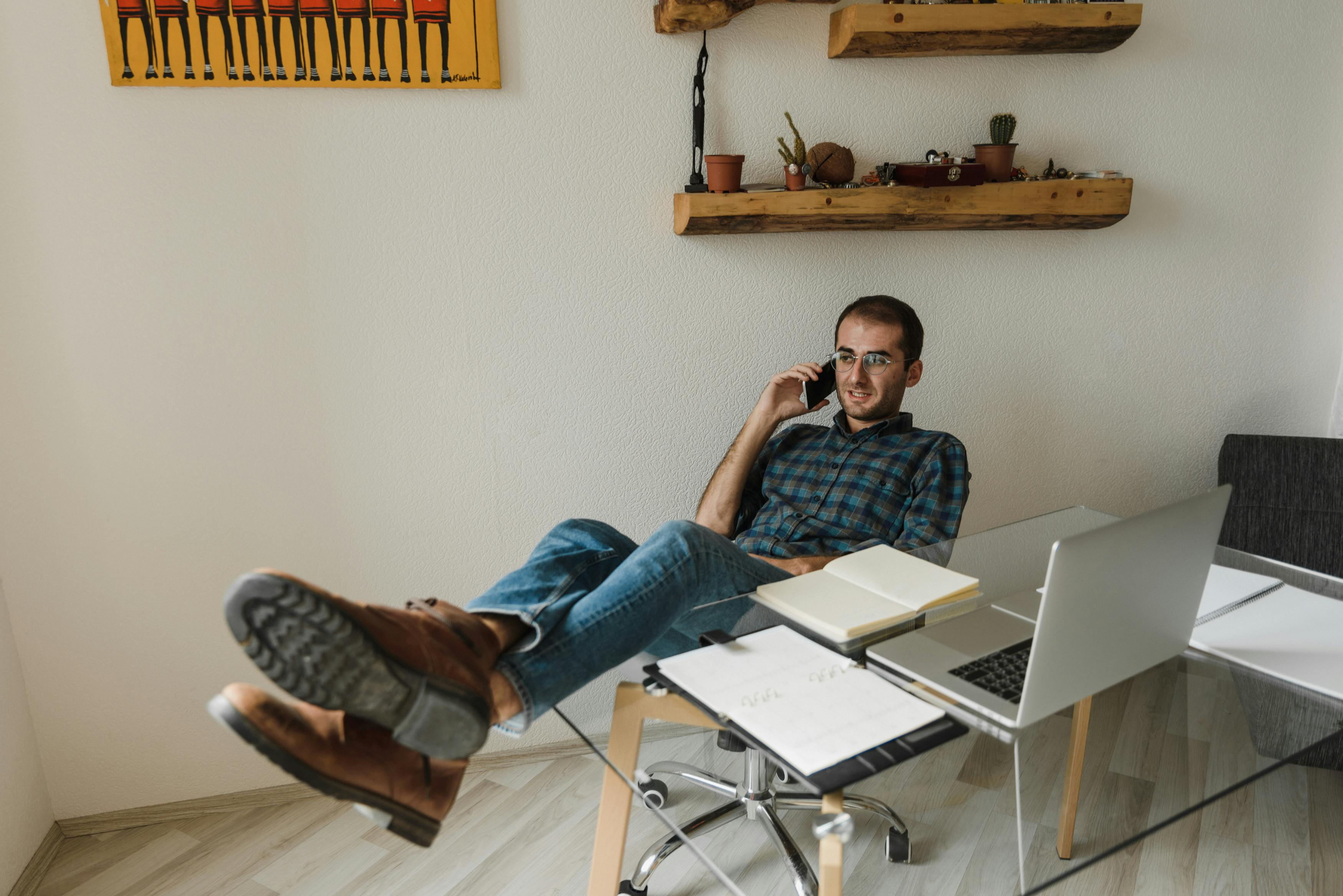 man in blue denim jeans sitting on chair