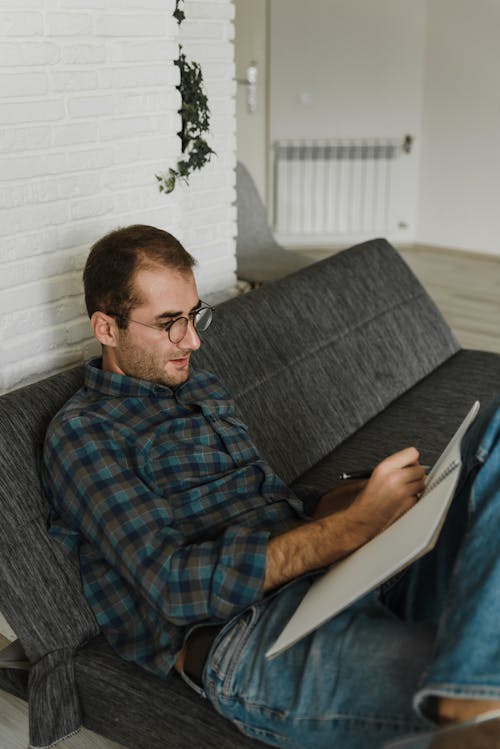 Man Sitting on a Sofa bed