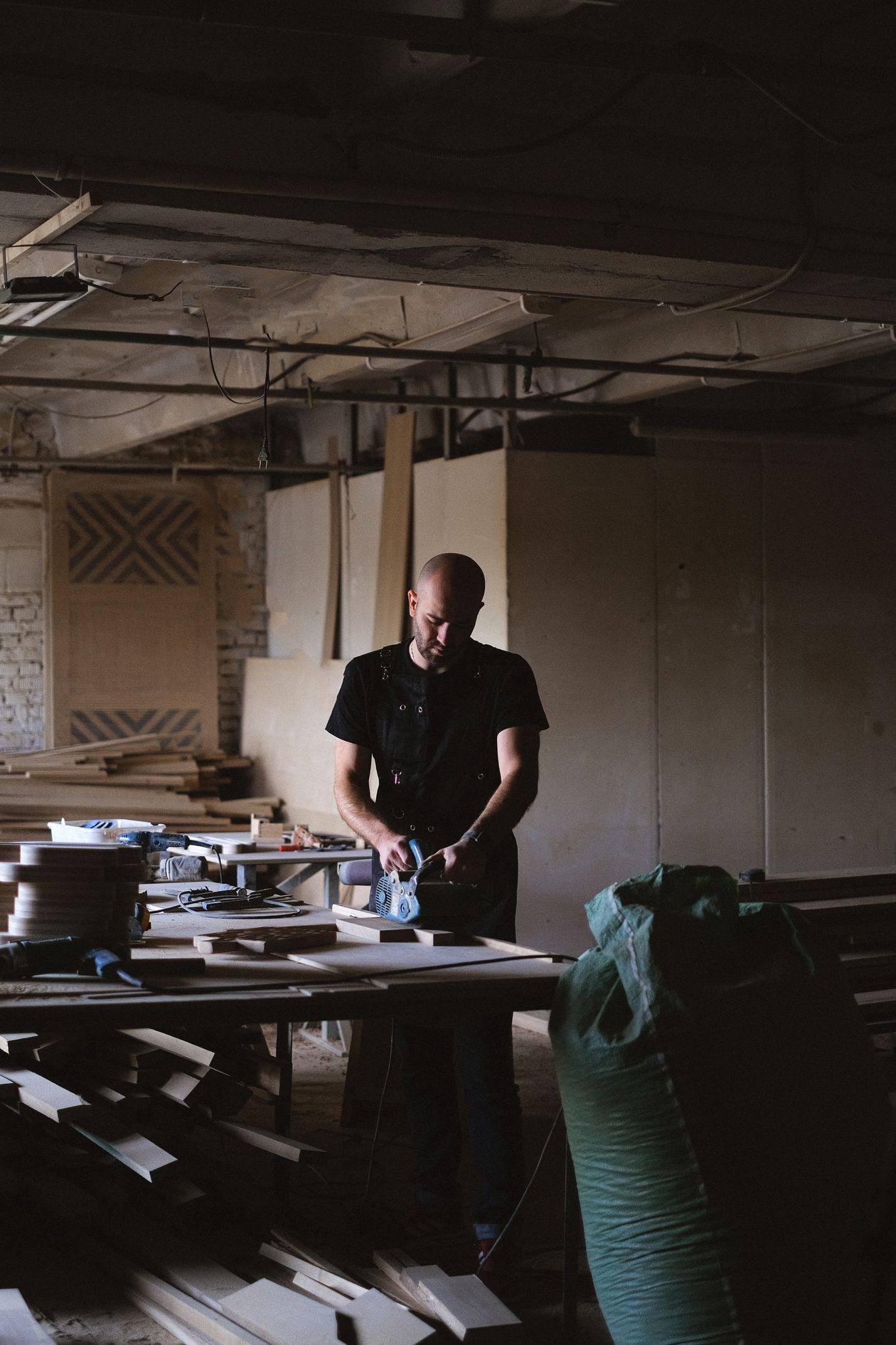 Craftsman building classroom furniture in the workshop