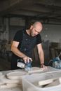 Focused artisan polishing wooden plank