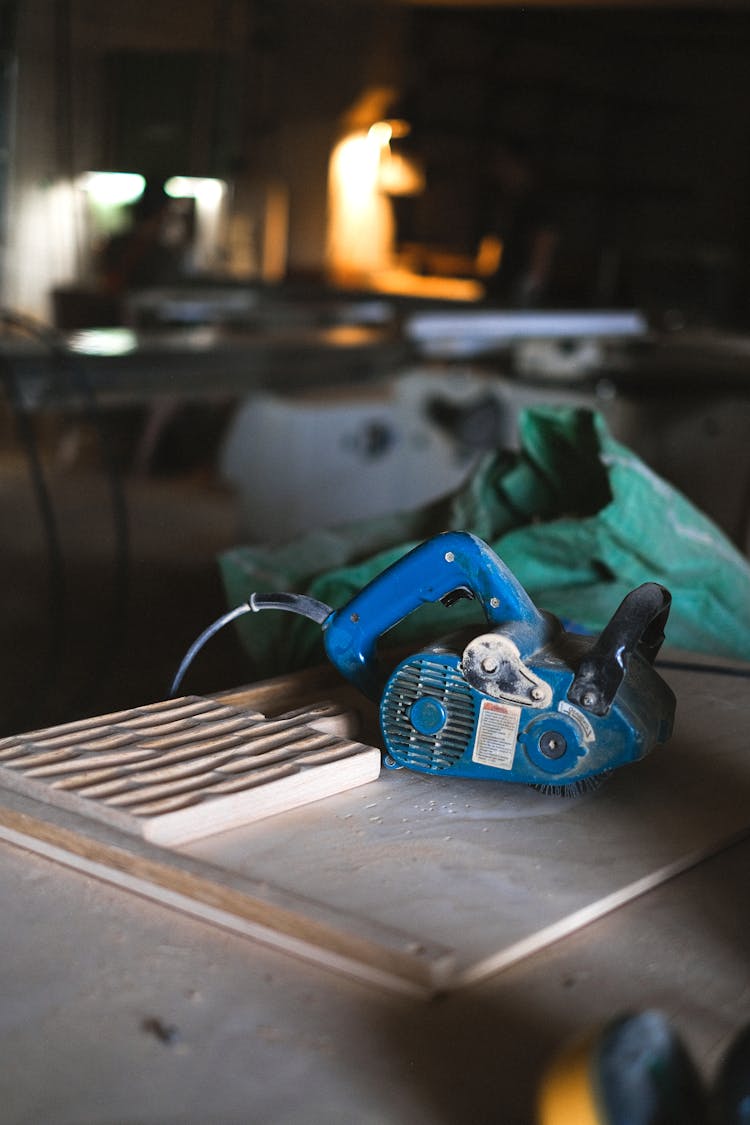 Belt Sander On Wooden Table In Workshop