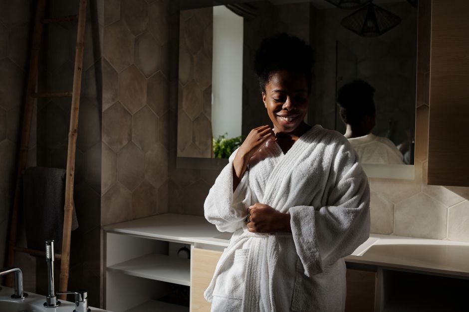 A confident person smiling, happy with their reflection in a mirror. - botox cost near me A confident person smiling, happy with their reflection in a mirror. - botox cost near me
