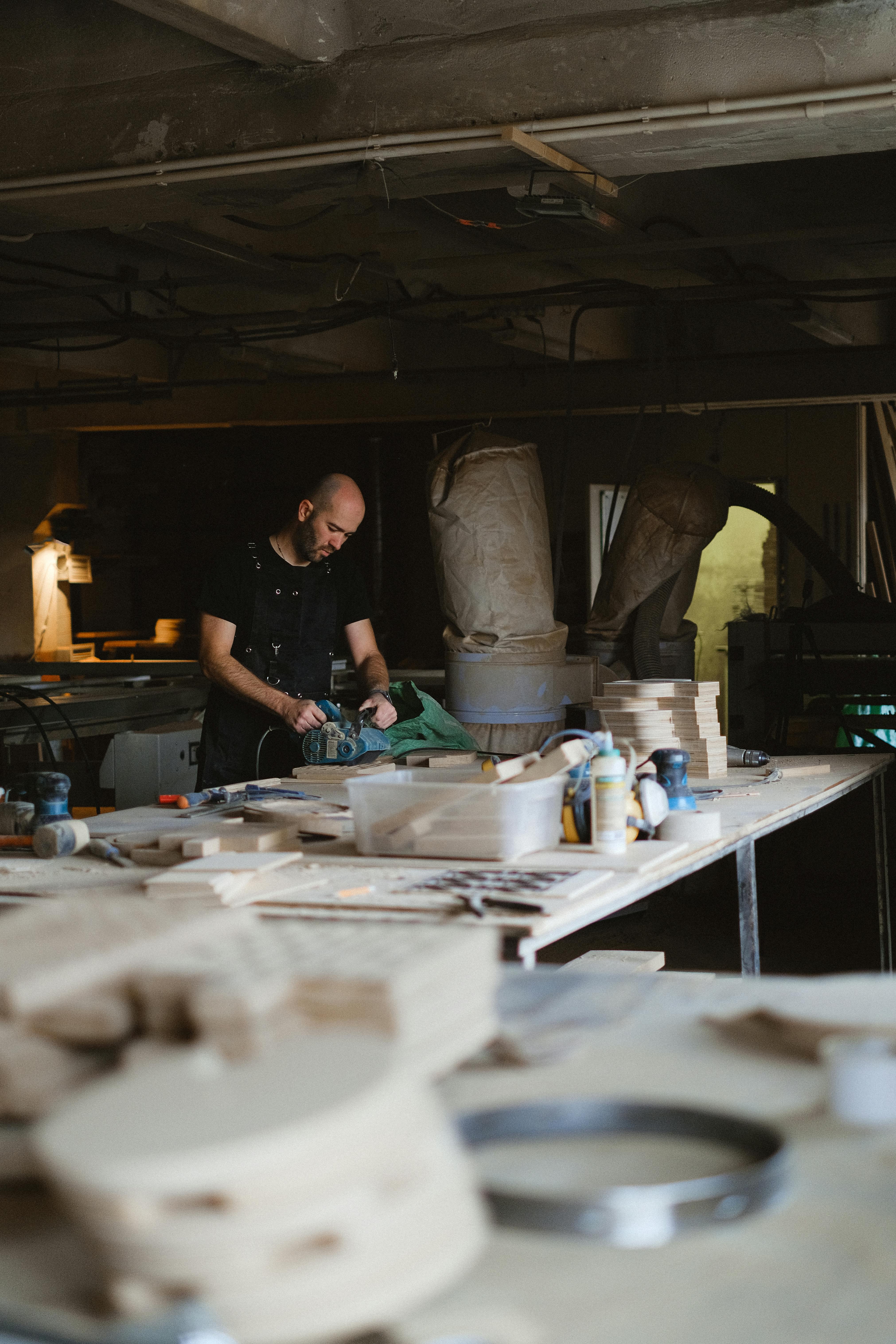 woodworker polishing wood in workshop