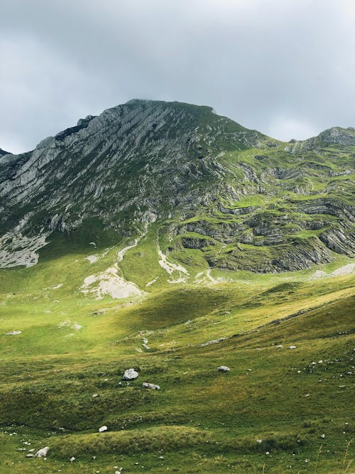 Green and Gray Mountain Under Cloudy Sky