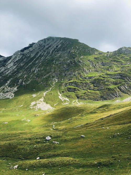 Free Scenic view of lush green mountains and valleys under cloudy sky in Montenegro. Stock Photo