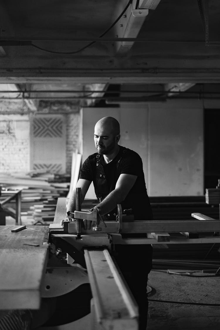 Focused Workman Working At Table Saw