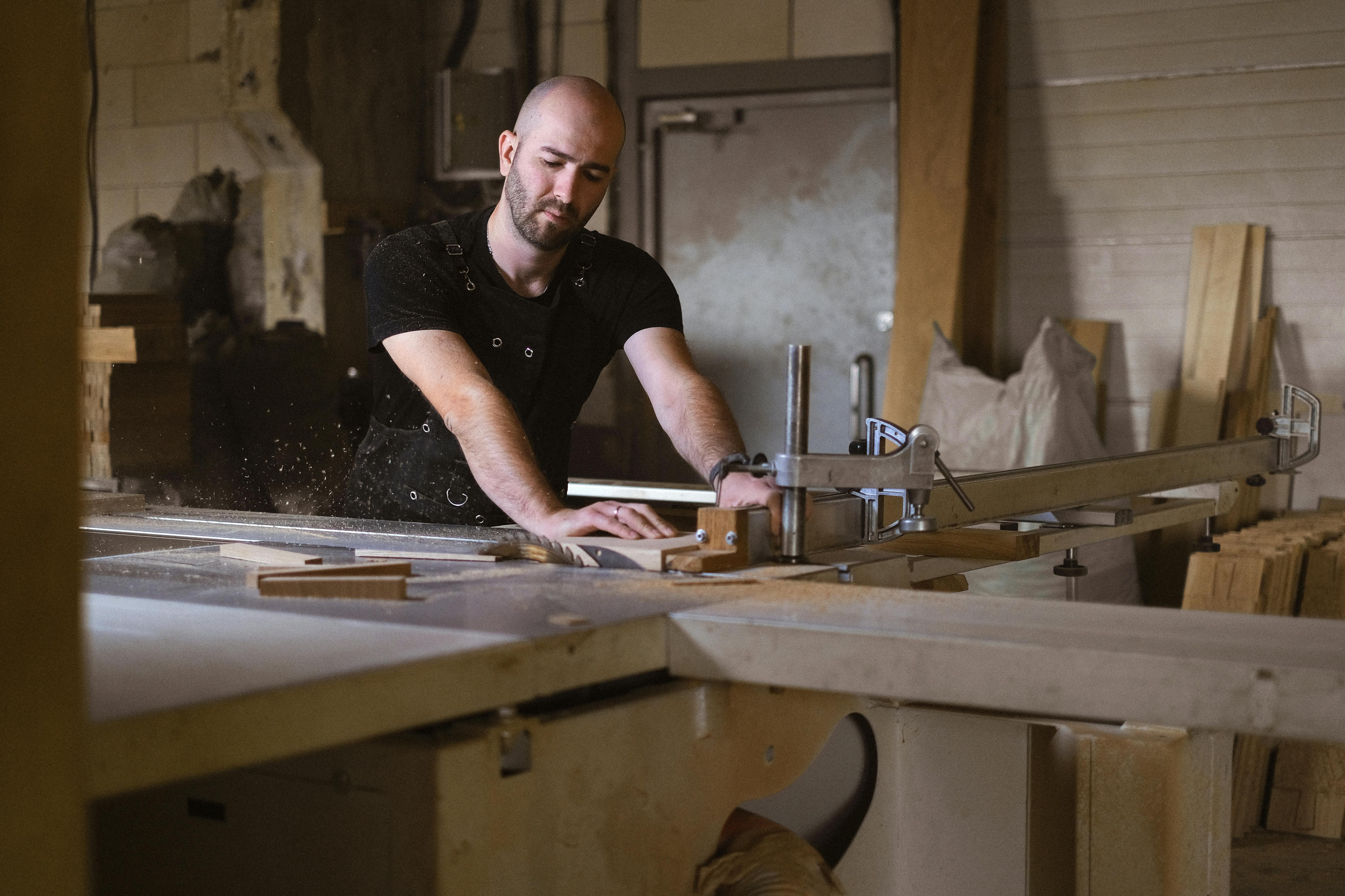 focused craftsman working with table saw