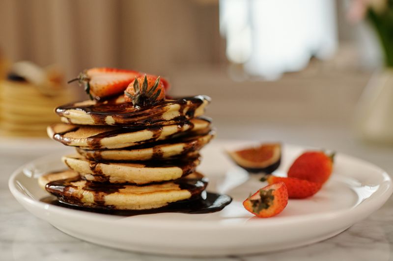 Ricotta hotcakes with roasted berries and pistachio at Grounded Coffee Co.