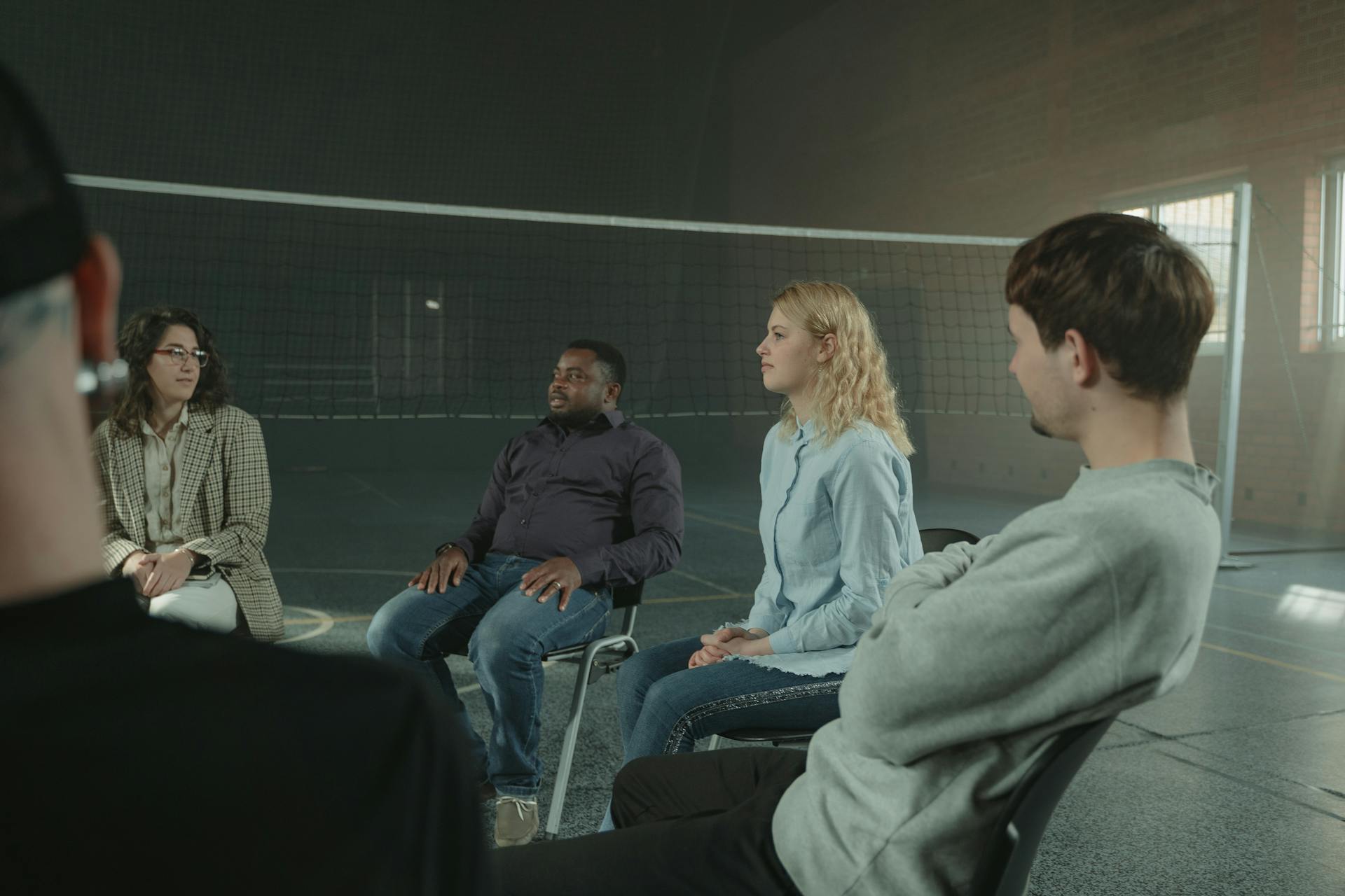 People attending a group therapy and recovery meeting