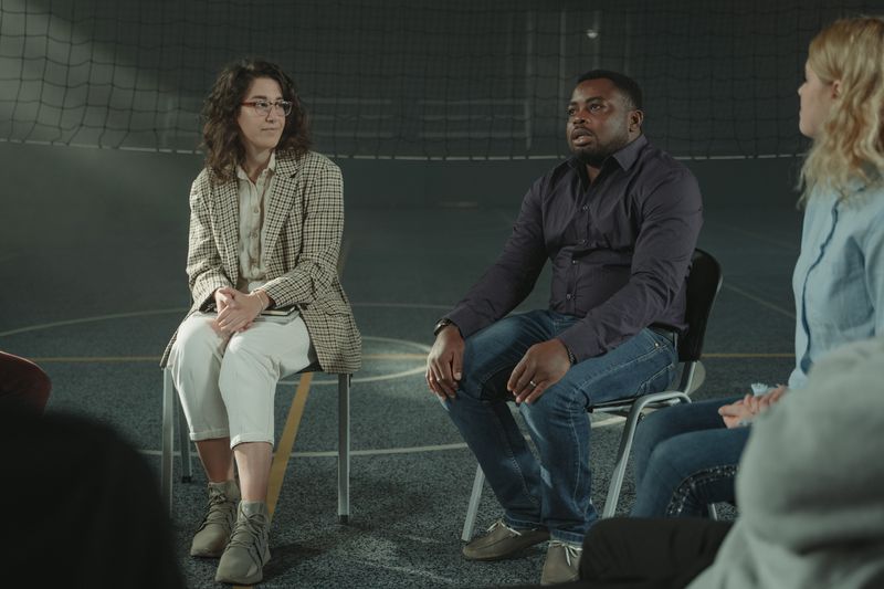 Support group session, low key lighting for anonymity