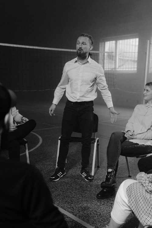 Free Participants engaging in a therapeutic group discussion indoors, fostering open communication. Stock Photo