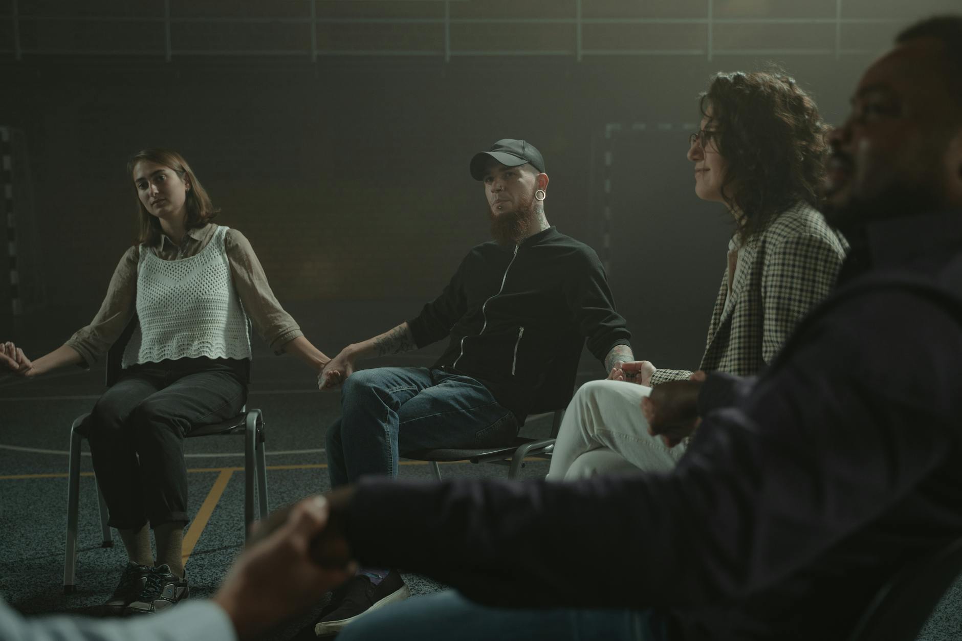 Man in Black Jacket Sitting on Chair