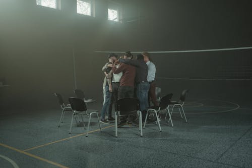 Friends Huddling in the Volleyball Court