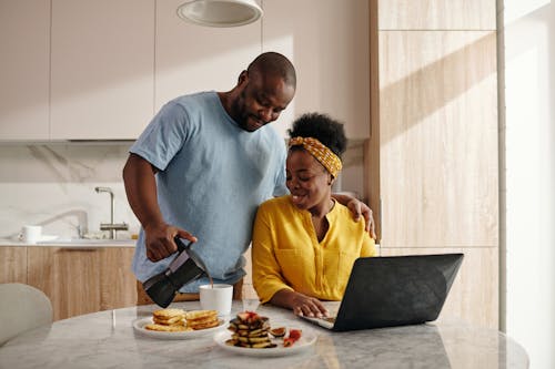 Free Man Serving Coffee to a Woman Stock Photo