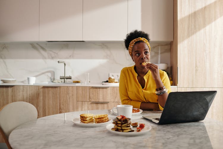 A Woman Alone Eating Food