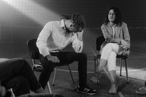 Free A therapy session with people discussing mental health in a supportive environment. Stock Photo