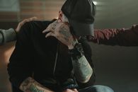 People Consoling a Man with Arm Tattoos