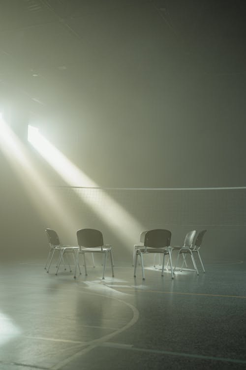 Chairs Arranged in Circle Inside  a Hall