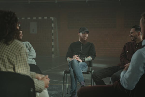 People sharing experiences in a group therapy session