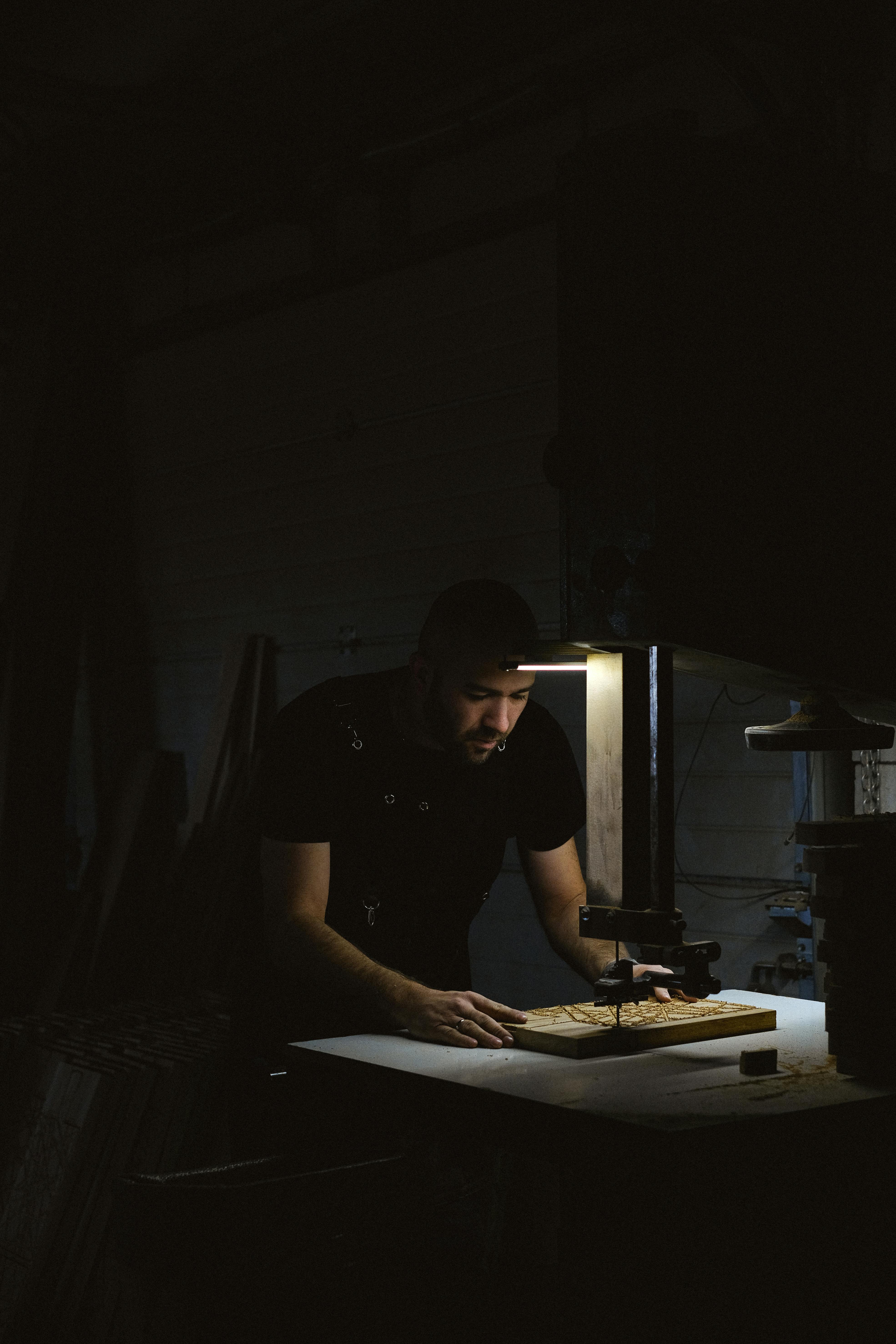 focused craftsman working with wooden details at workbench