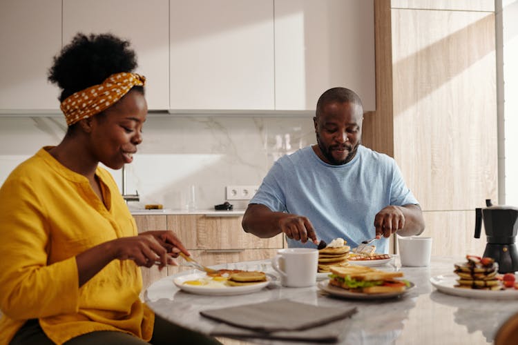 Happy Couple Eating Breakfast Together