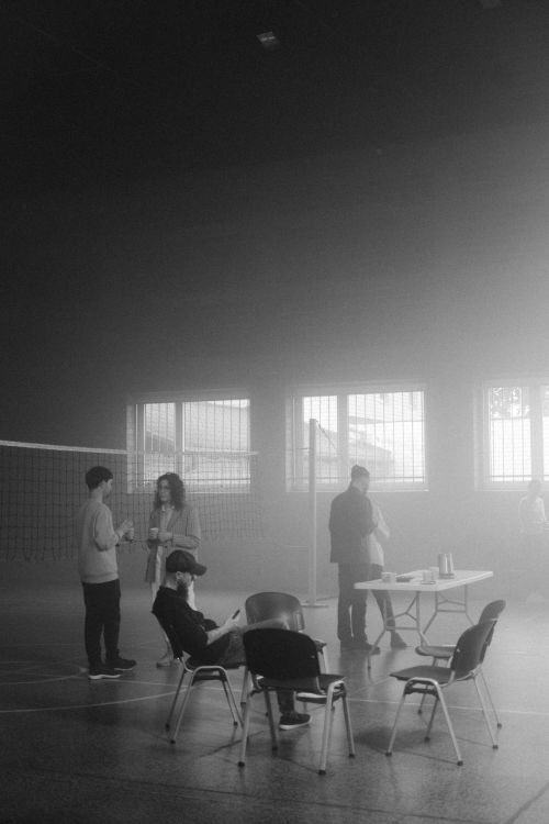 Free People gathered in a smoky room with chairs and a table, creating a mysterious ambiance. Stock Photo