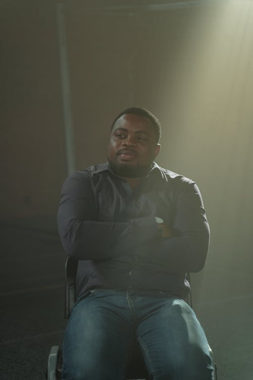 A Man Sitting while Arms Crossed 
