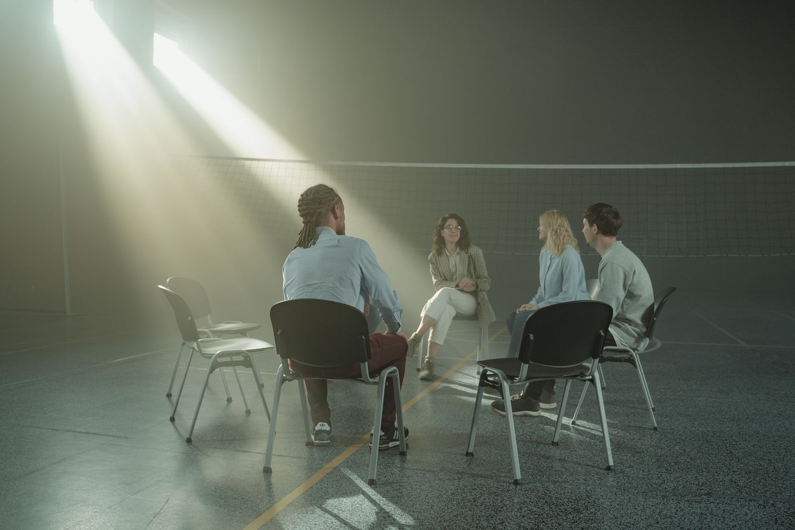 A diverse group of adults seated together in a supportive discussion, illustrating the value of peer connection