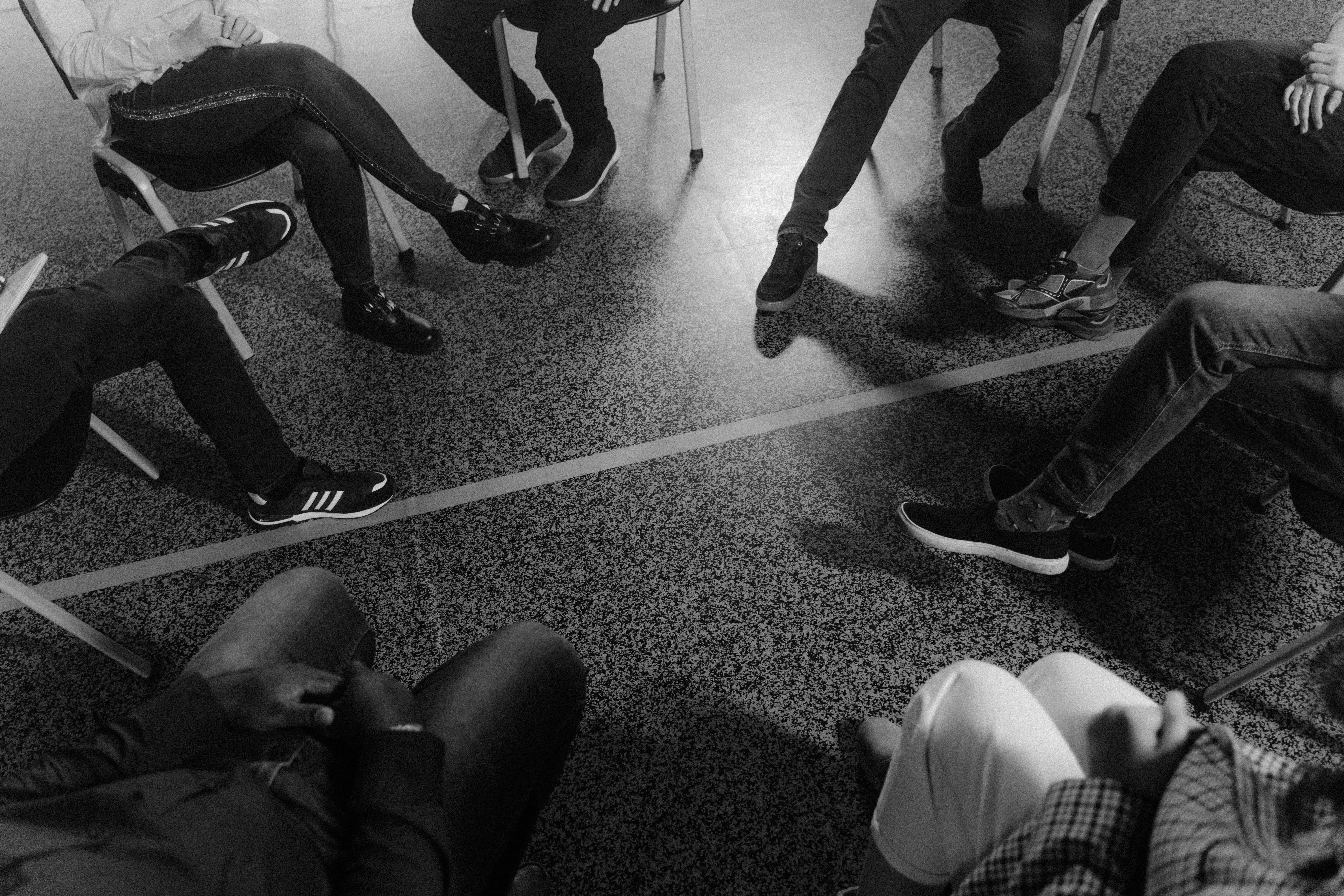 grayscale photo of people wearing shoes